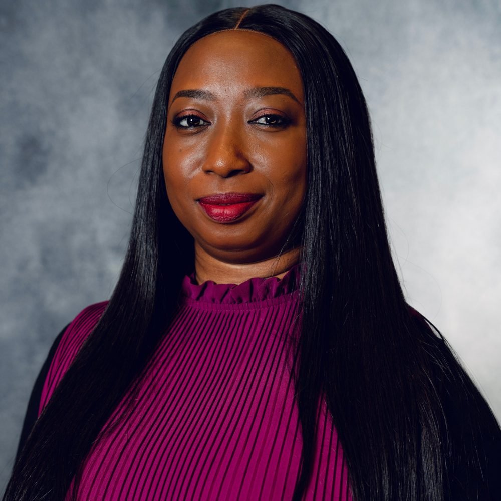 Headshot of Kemi in a plum top