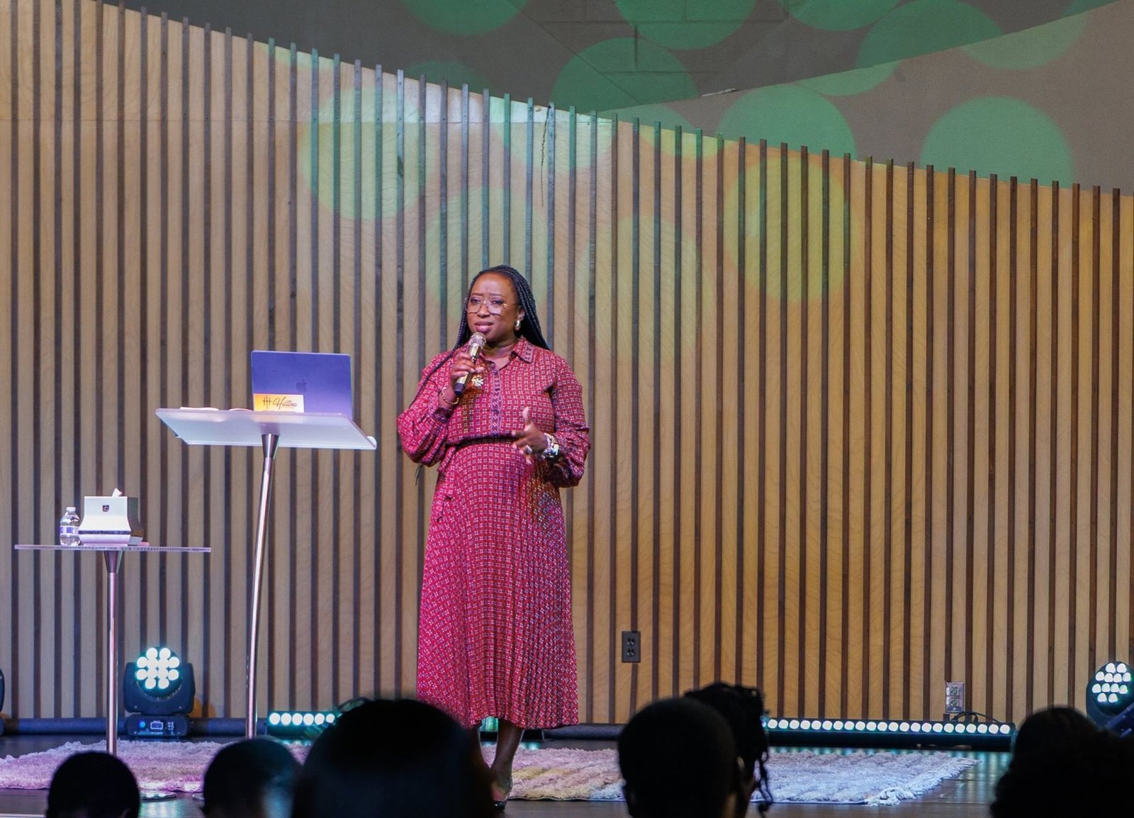Kemi on stage addressing a full room